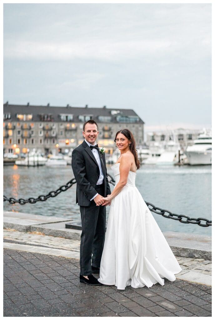 Boston skyline and harbor backdrop for romantic wedding portrait.