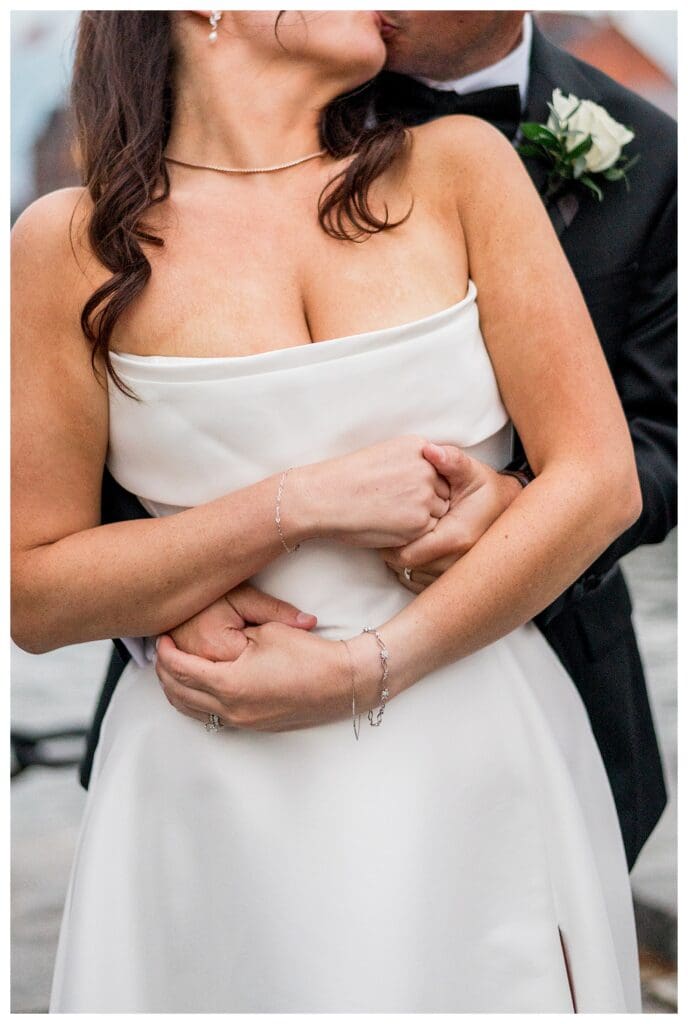Couple embracing at Boston harbor hotel wedding.