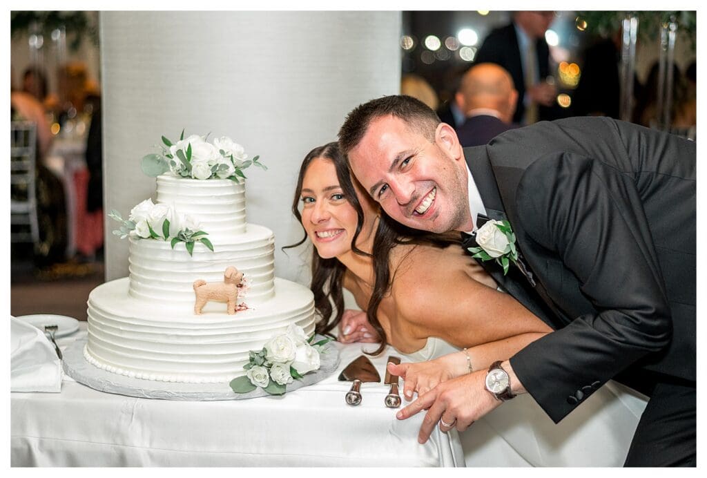 Custom cake topper with dog at Boston waterfront reception.
