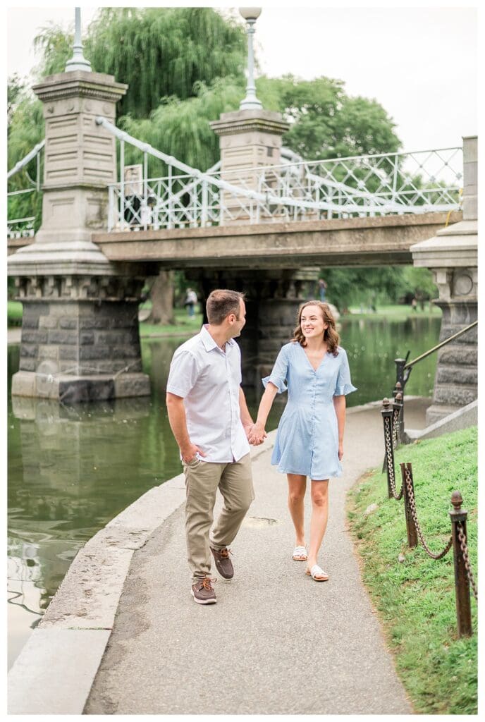 Couple walking hand in hand along path in Boston Public Garden, Boston engagement photos