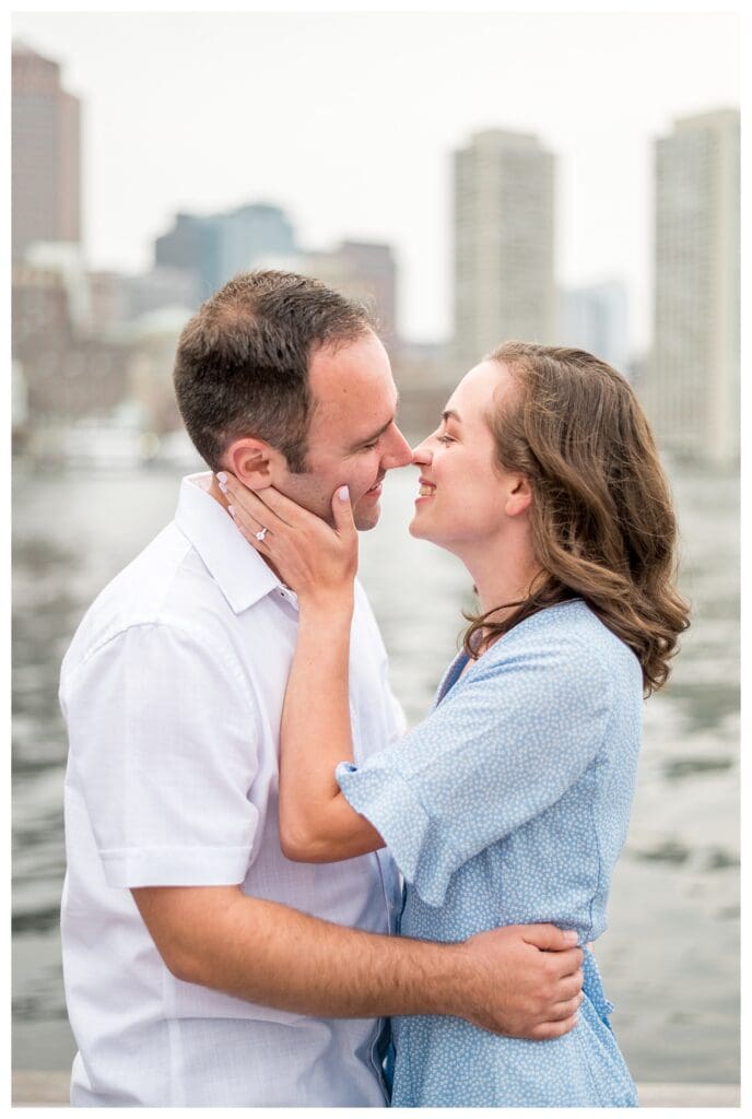 Close-up of couple kissing with Boston skyline in background, Boston photographer
