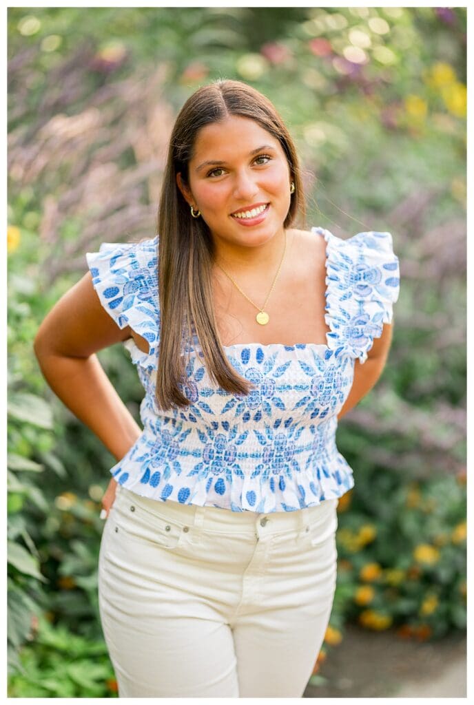 Senior portrait with blue top and floral background