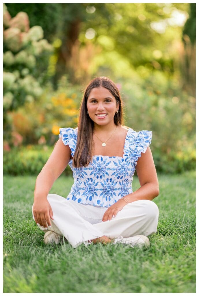 Twin senior sitting and smiling in garden setting