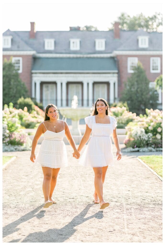 Dana Hall seniors walking through Elm Bank gardens holding hands