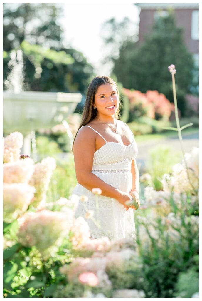 Bright senior photos with warm sunlight and flowers