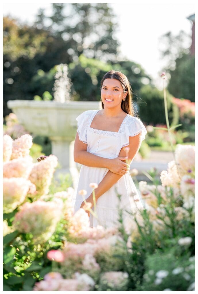 Dana Hall senior smiling in garden during sunset light