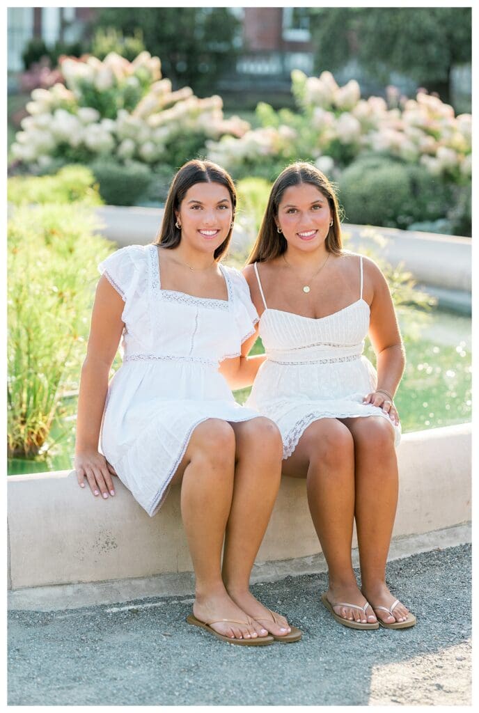Twin seniors posing with arms around each other