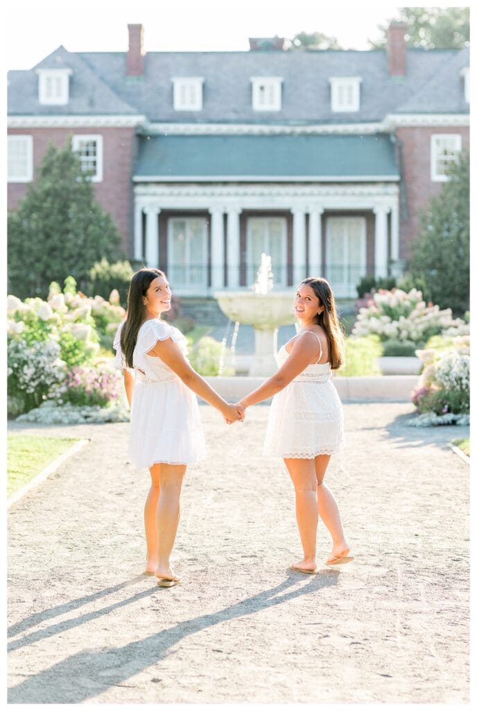 Dana Hall senior photos of twin sisters in white dresses at Elm Bank