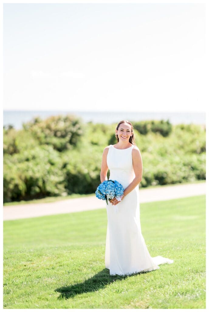 Bride standing on lawn at Nauset Beach Inn Wedding venue