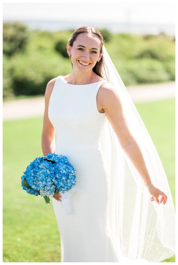 Bride holding blue hydrangea bouquet