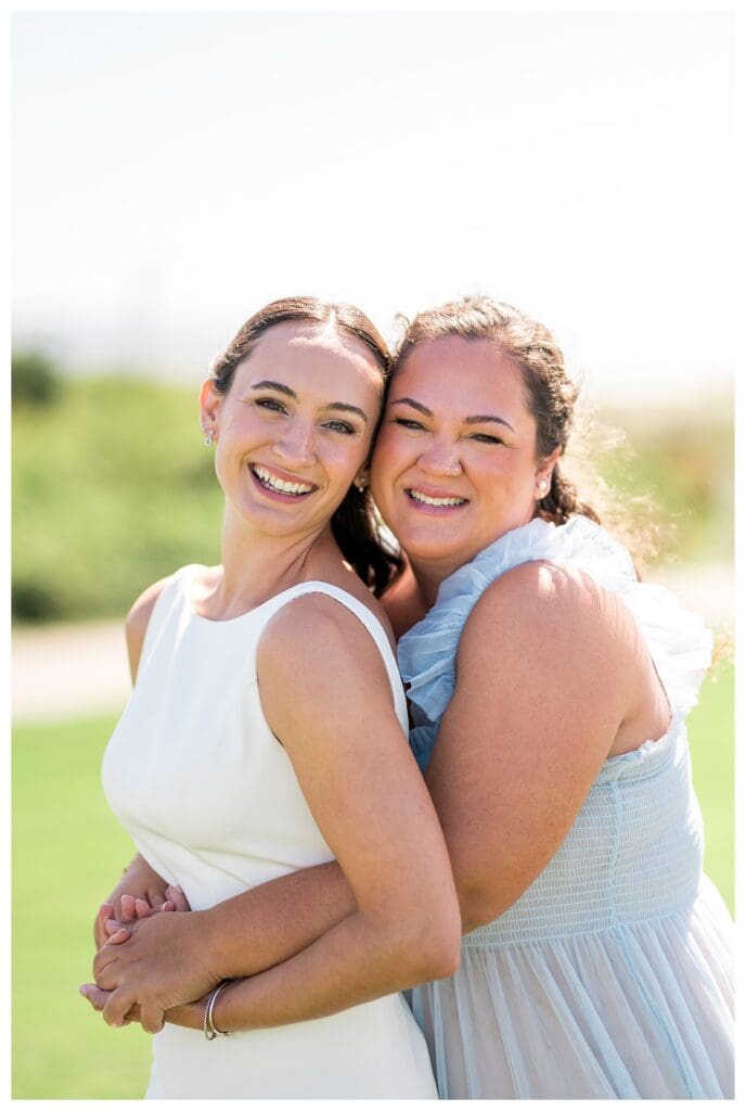 Bride and sister hugging before ceremony