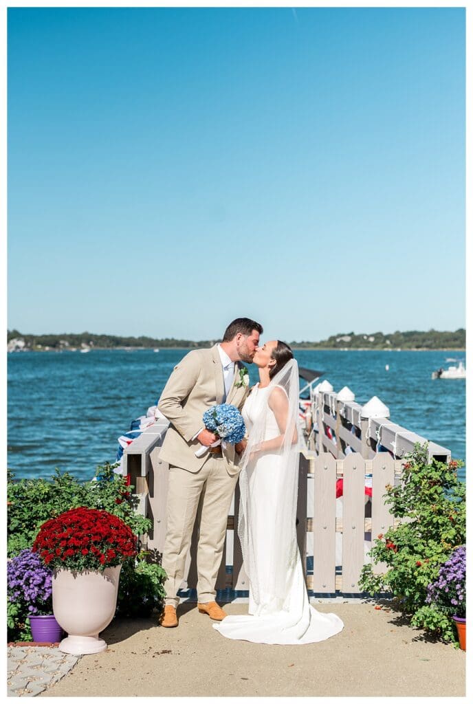 Couple kissing by the ocean at Cape Cod wedding