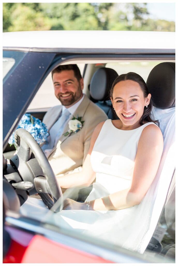Couple in red car wedding portrait