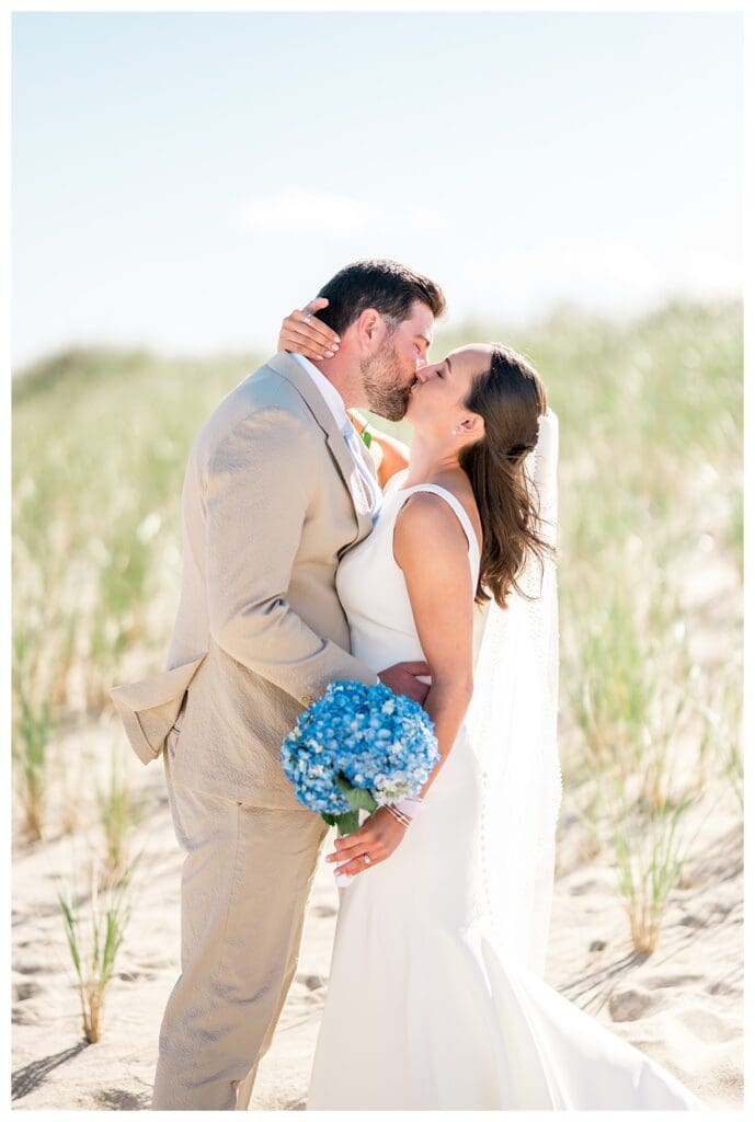 Bride and groom kissing on the beach during Cape Cod wedding
