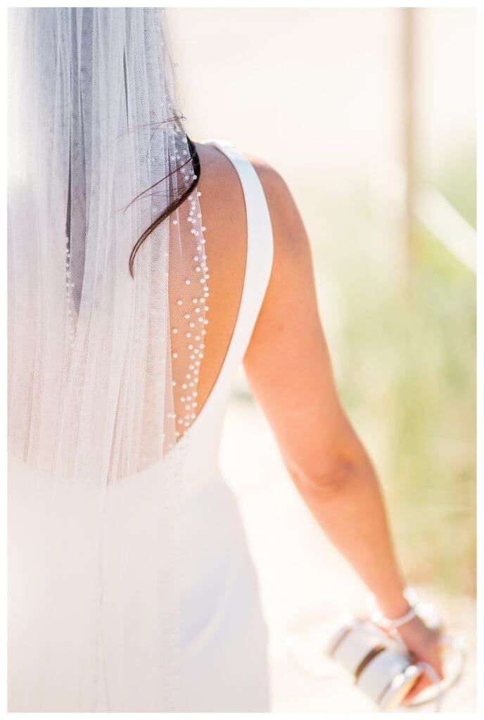 Bride walking through beach grass detail shot