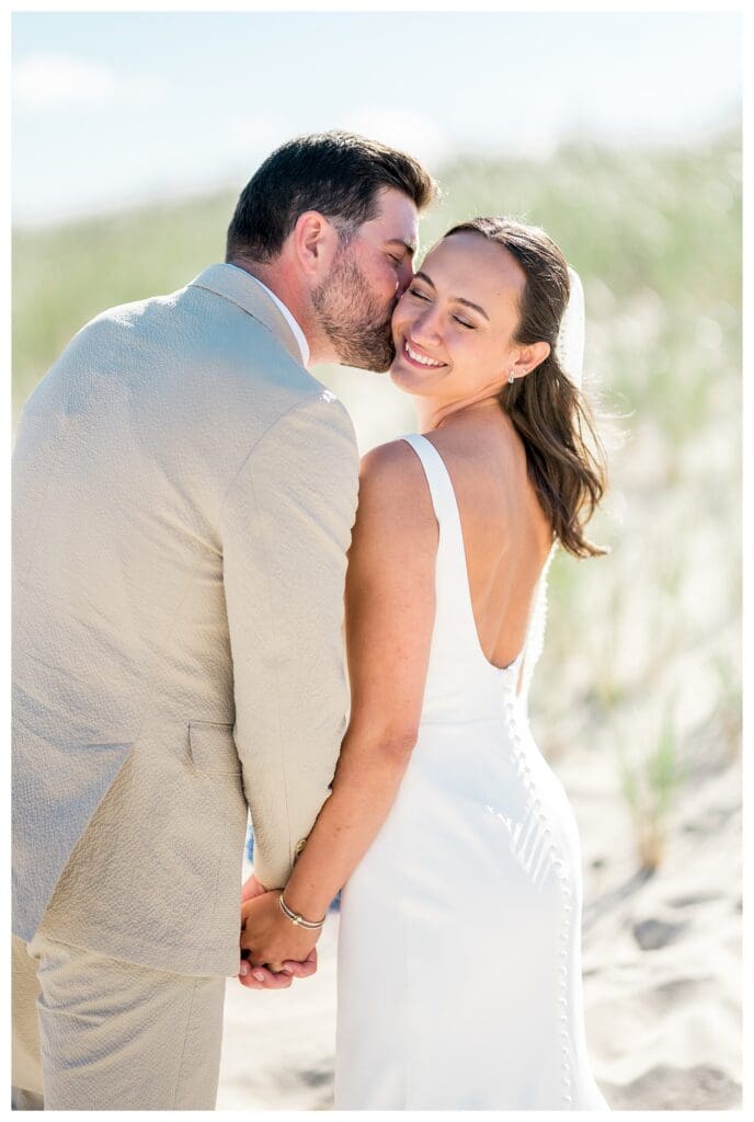Groom kissing bride on the cheek