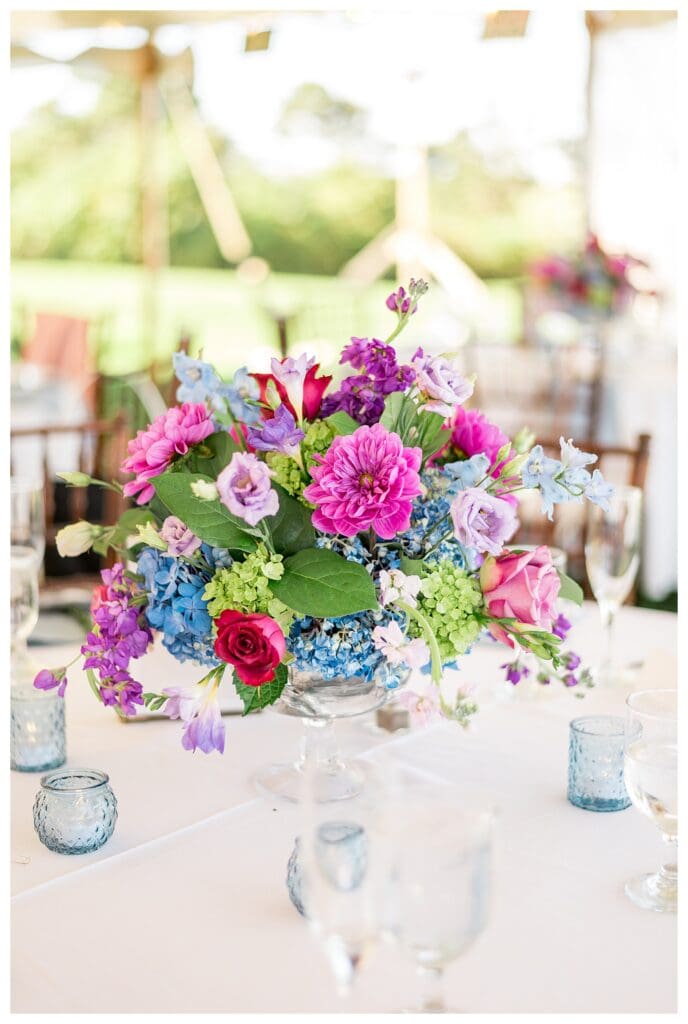 Colorful coastal wedding centerpiece with florals