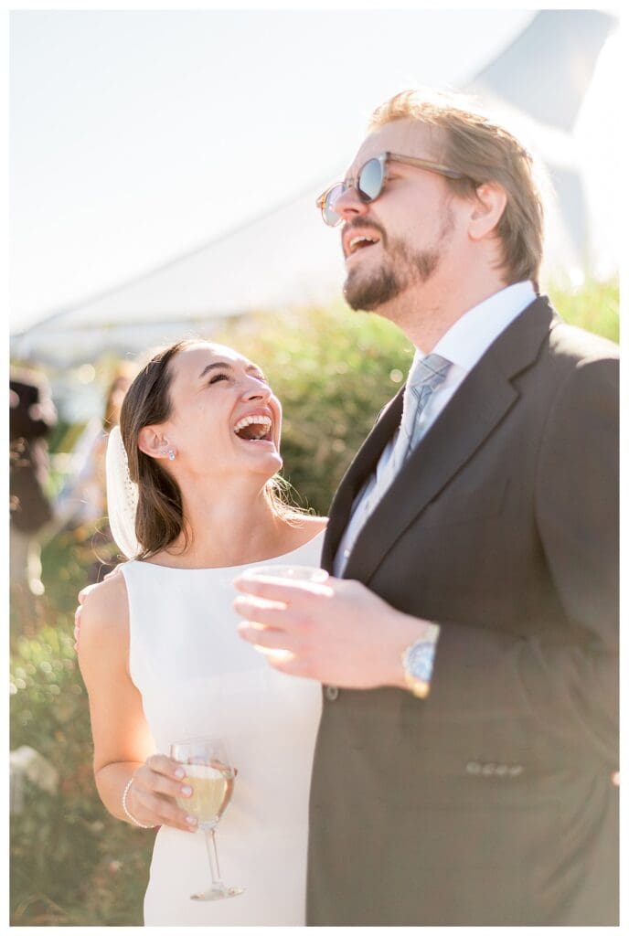 Bride and guest laughing together candid moment