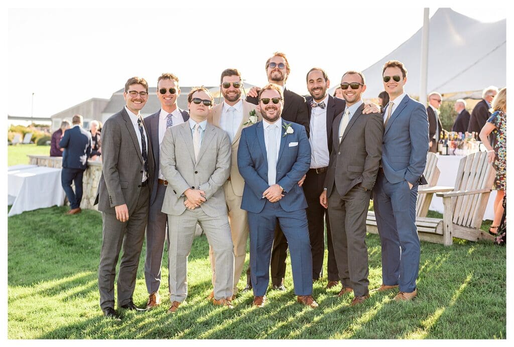 Groom and friend group portrait on lawn