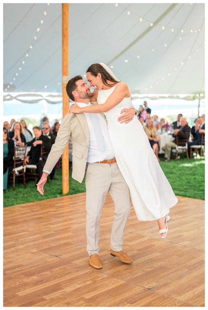 Couple dancing under tent lights