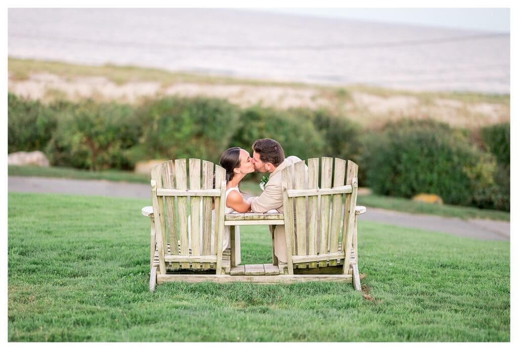 Couple sitting in Adirondack chairs at sunset