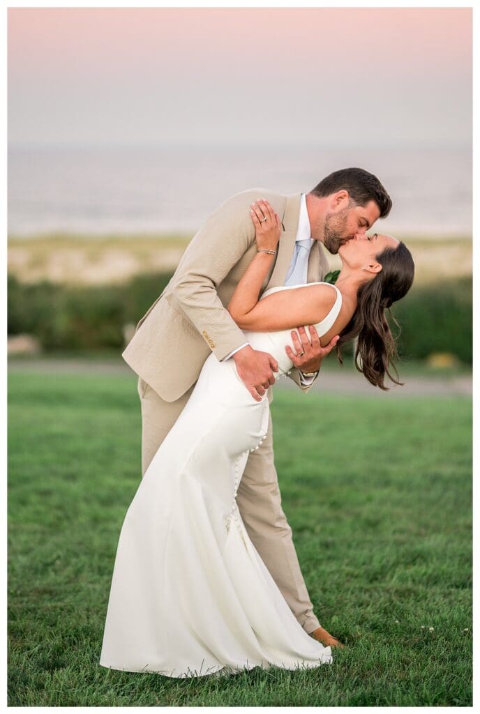Groom dipping bride during sunset portrait