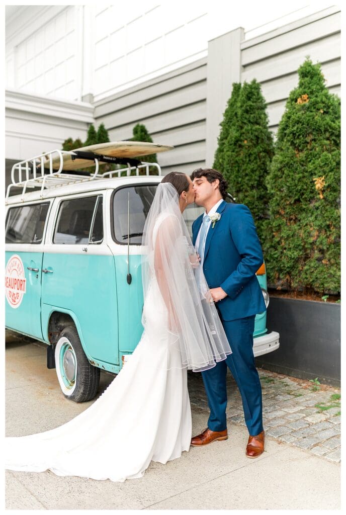 Bride and groom kissing beside Beauport vintage Volkswagen bus