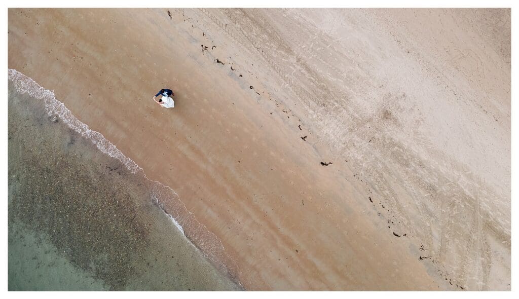 Drone photography of bride and groom on sandy beach at Beauport Hotel