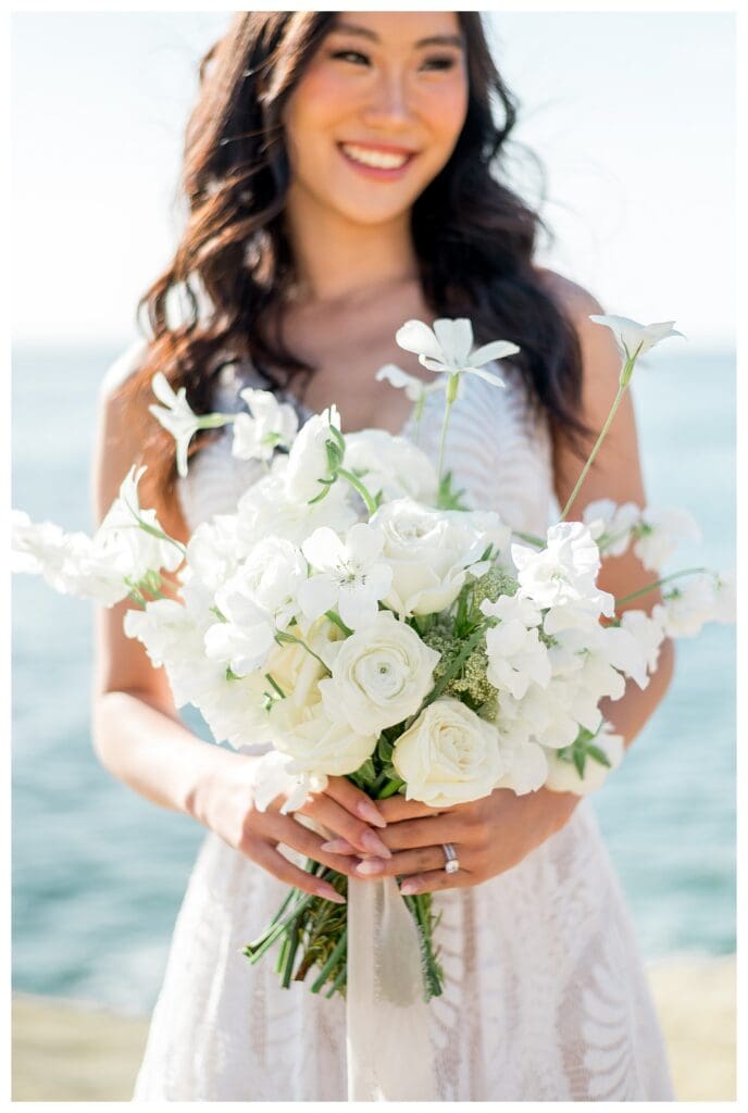 Bride portrait holding white bouquet at Sunset Cliffs San Diego elopement photography.