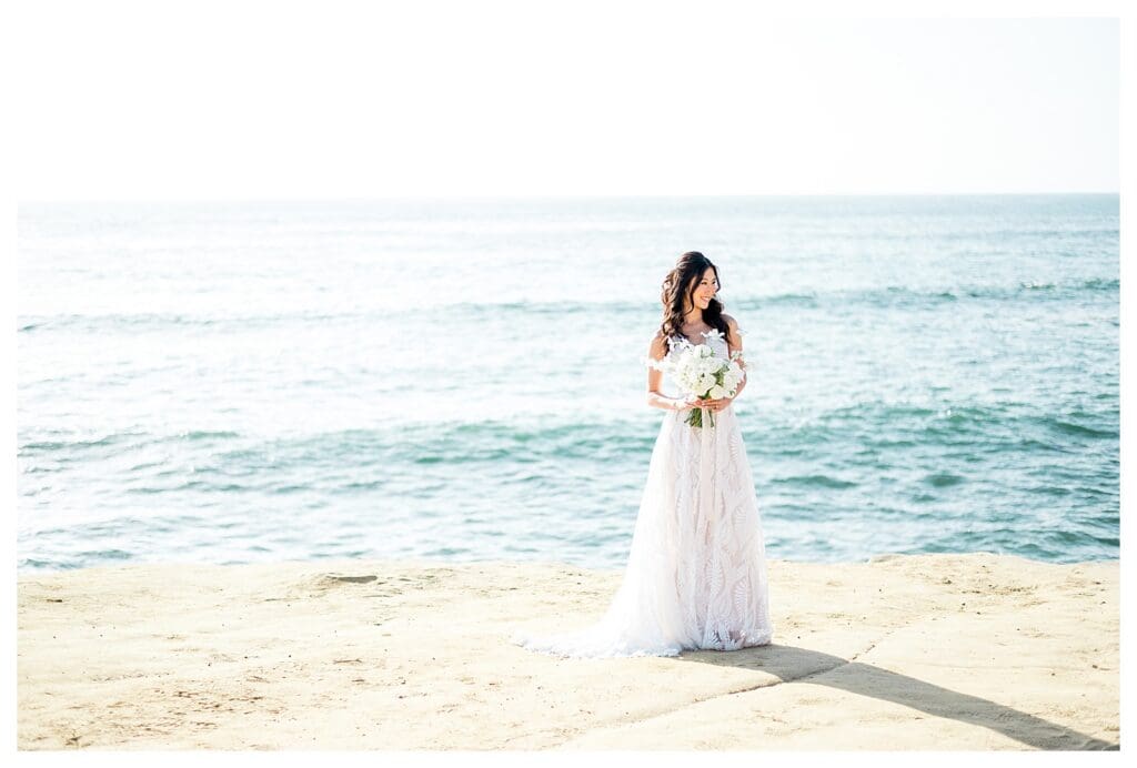 Bride in white dress with ocean view at Sunset Cliffs San Diego elopement styled shoot.