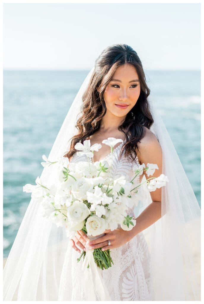 Bride in white gown with ocean backdrop at Sunset Cliffs San Diego elopement photography by Sarah Surette.