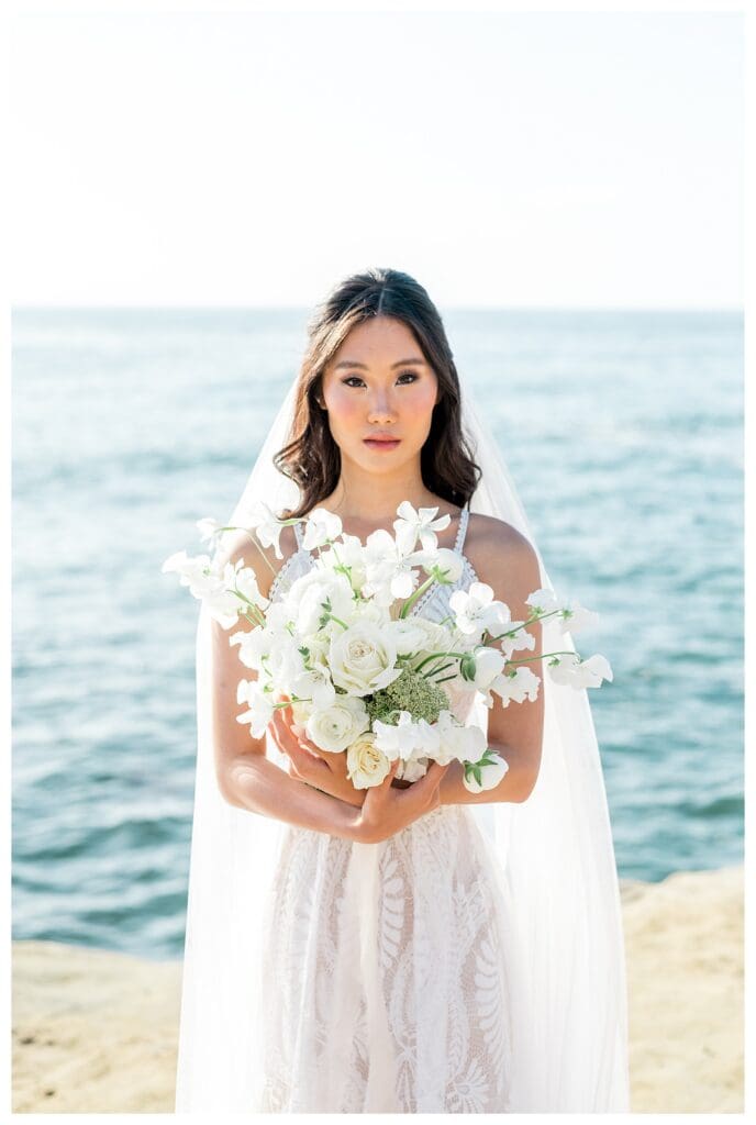 Bride portrait with white floral bouquet at Sunset Cliffs San Diego elopement photography.
