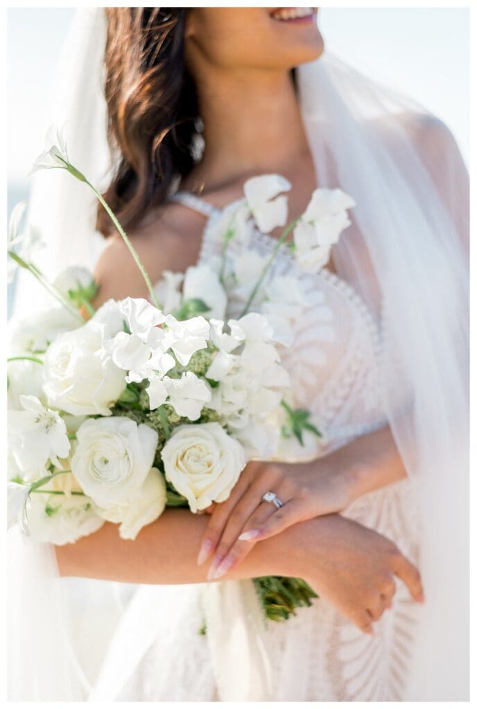 Detail shot of bride holding white rose and floral bouquet at San Diego coastal elopement.