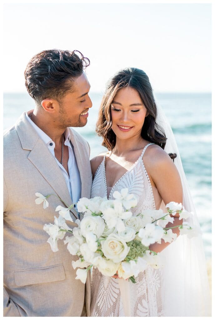 Bride and groom close-up portrait with ocean behind them at Sunset Cliffs San Diego elopement.