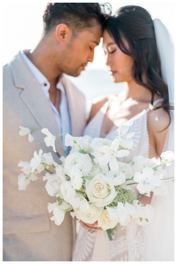 Groom holding bride close at Sunset Cliffs San Diego elopement photography.
