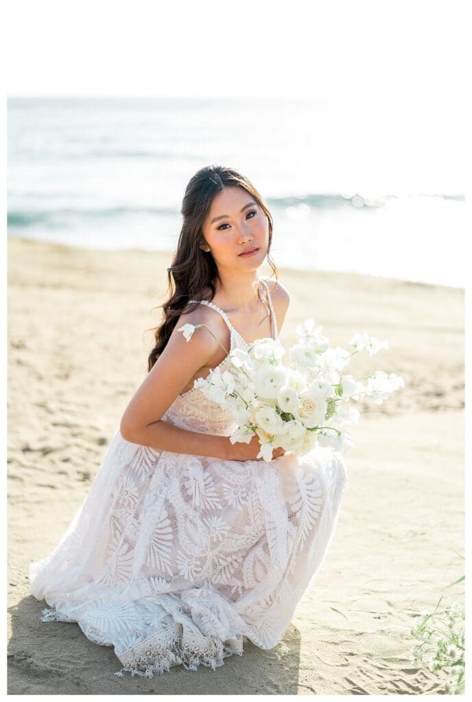 Bride holding white bouquet at Sunset Cliffs San Diego elopement photography by Sarah Surette.