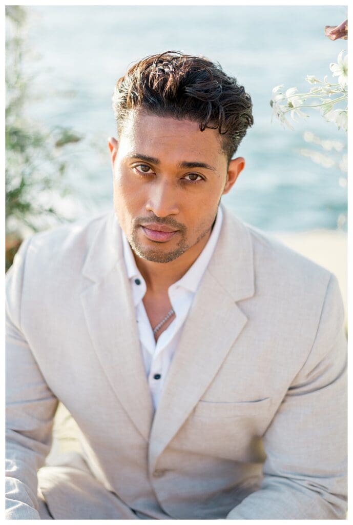 Close-up portrait of groom looking toward ocean at Sunset Cliffs San Diego styled shoot.