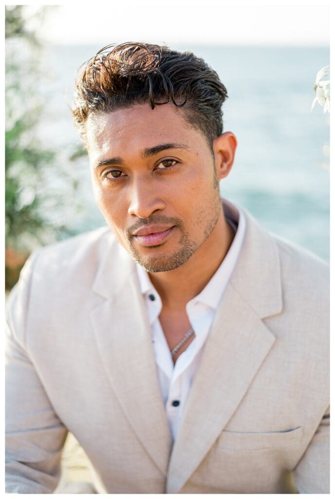 Close-up portrait of groom in cream suit at Sunset Cliffs San Diego elopement photography.