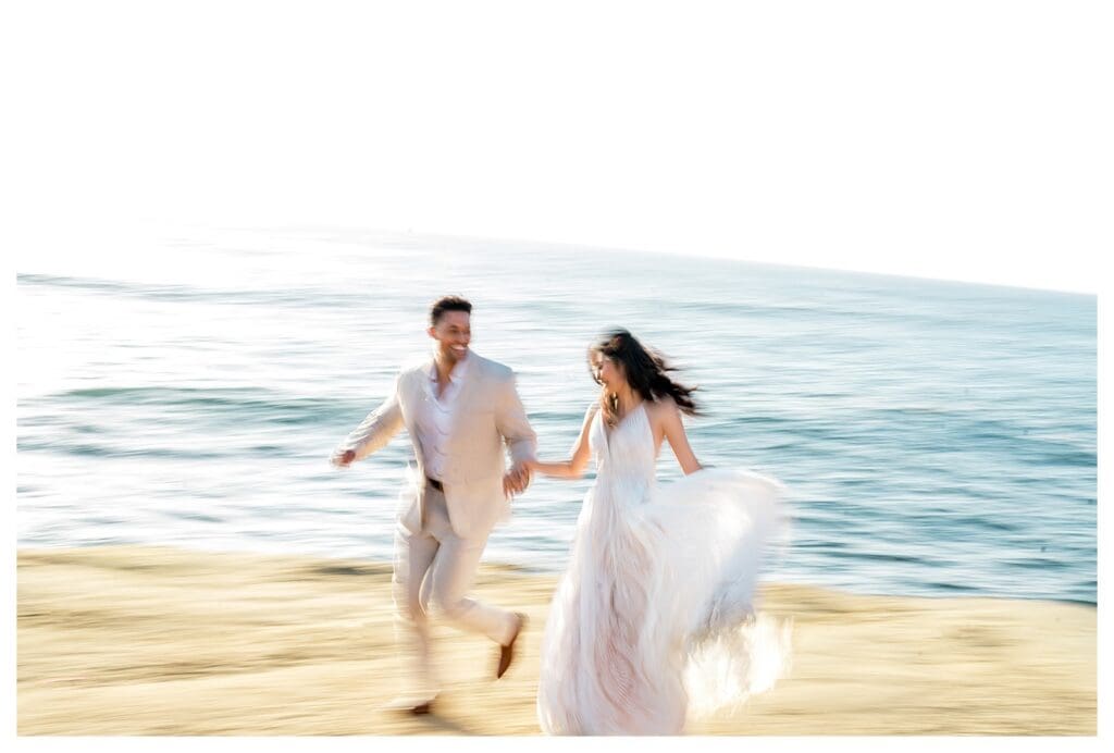 Couple running and laughing on the beach at Sunset Cliffs San Diego elopement styled shoot.