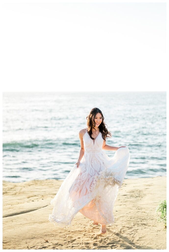Bride in white dress running along Sunset Cliffs San Diego.