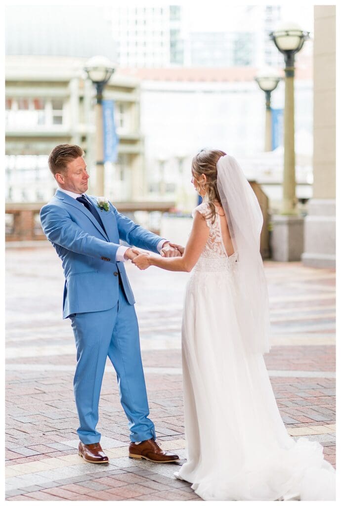 Groom looking at bride lovingly during portraits at Boston Harbor Hotel