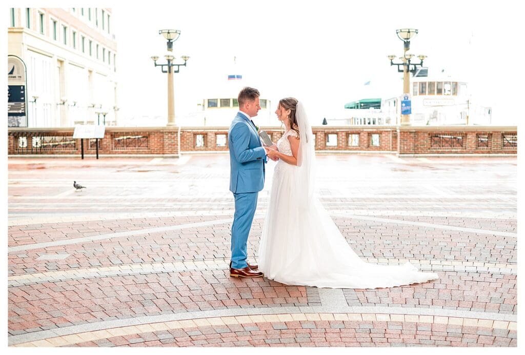 Bride and groom romantic portrait at Boston Harbor Hotel with harbor in background
