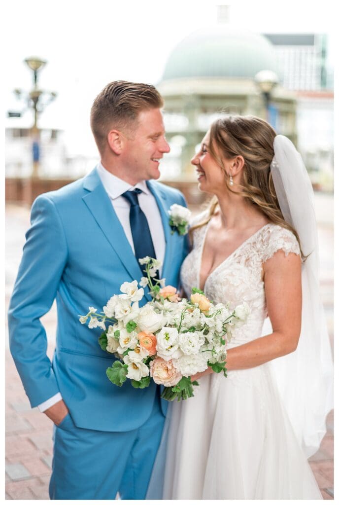 Bride smiling and laughing with groom during portraits at Boston Harbor Hotel