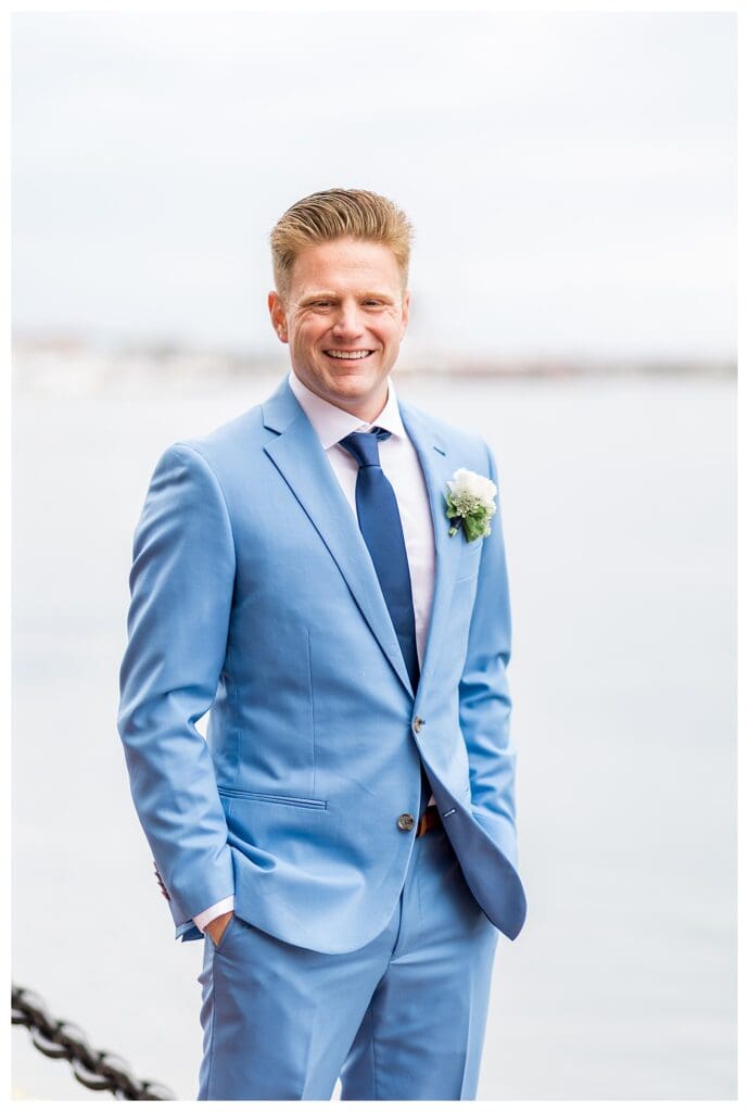 Groom smiling at bride during Boston Harbor Hotel wedding portraits