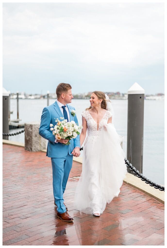 Bride and groom smiling together on the Boston Harbor Hotel waterfront