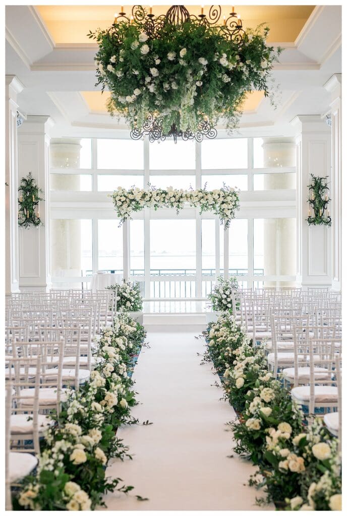 Ceremony detail of white chuppah and floral arrangements at Boston Harbor Hotel