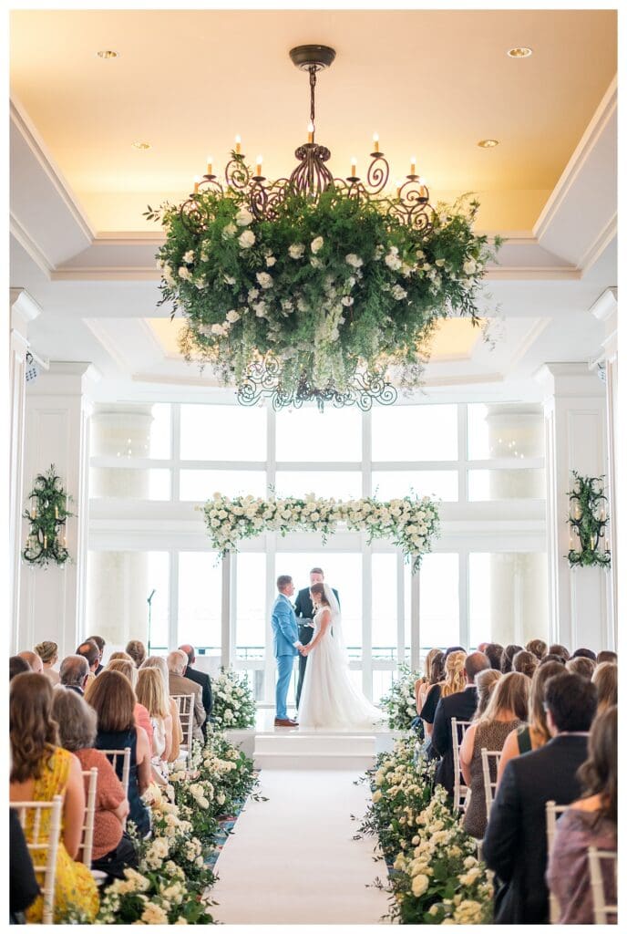 Full wedding ceremony at Boston Harbor Hotel with guests and floral chuppah
