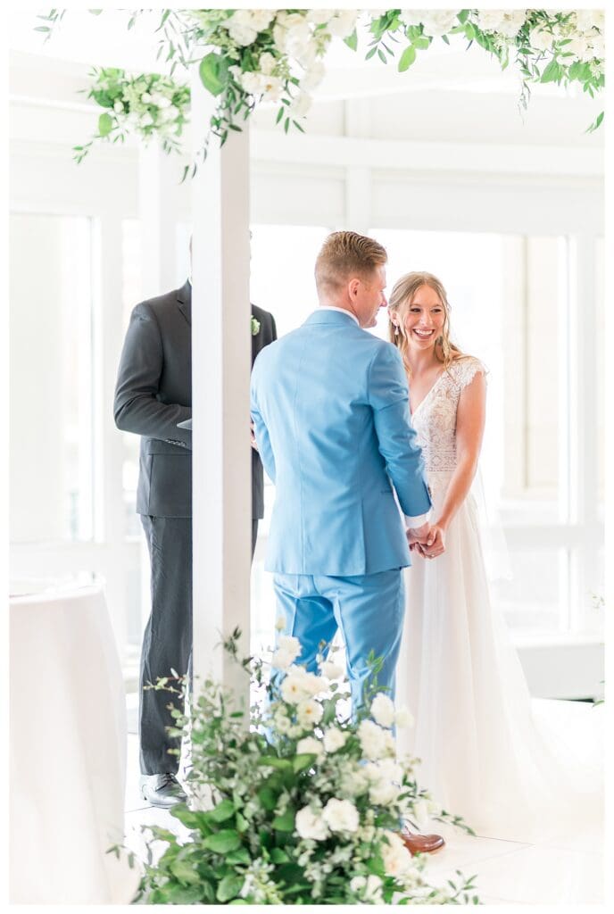 Bride and groom sharing a moment at the altar during Boston Harbor Hotel wedding ceremony