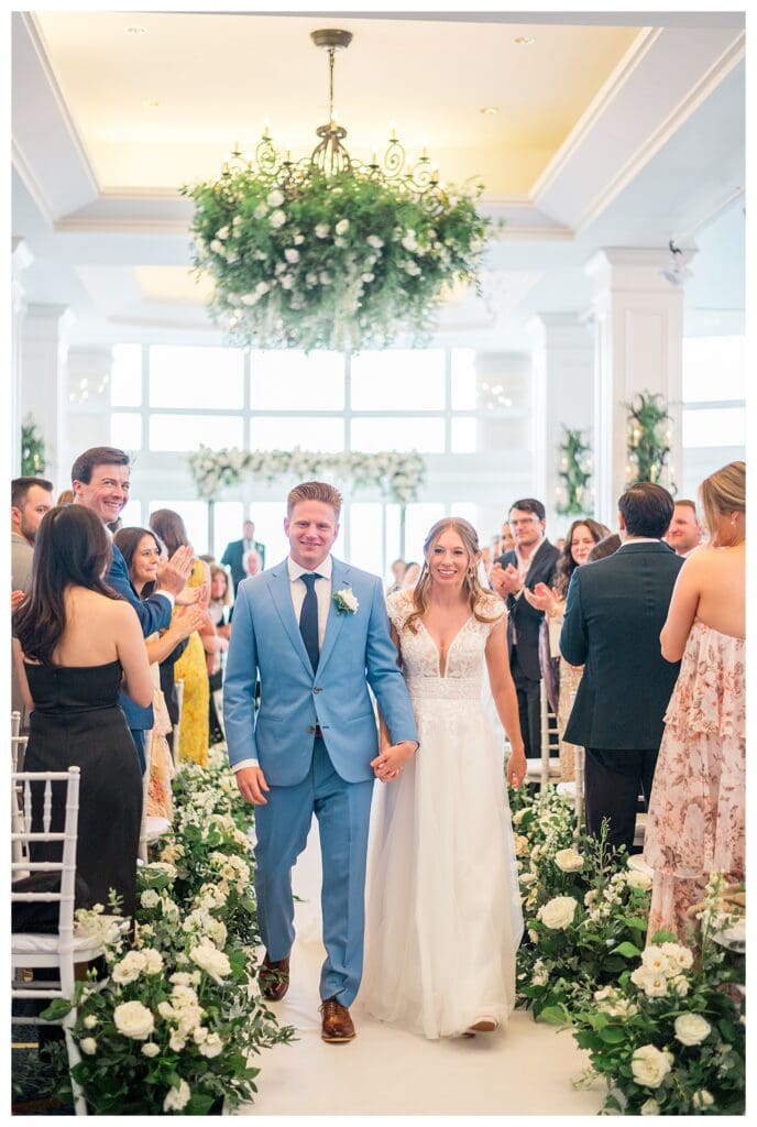 Bride and groom smiling during ceremony recessional at Boston Harbor Hotel