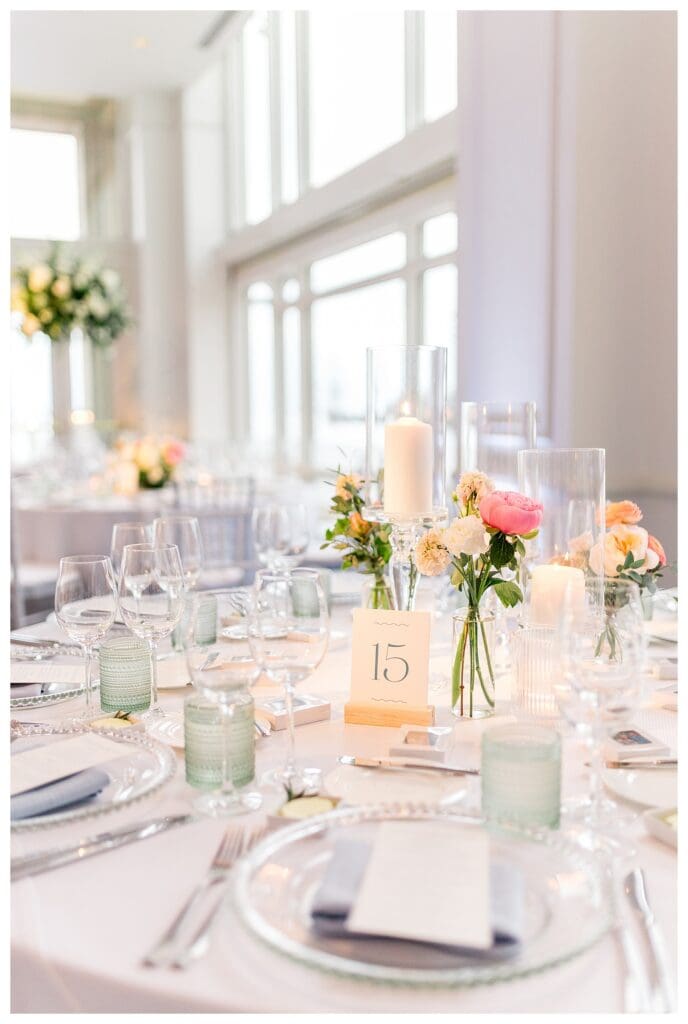 Floral centerpiece and table signage detail at Boston Harbor Hotel wedding reception